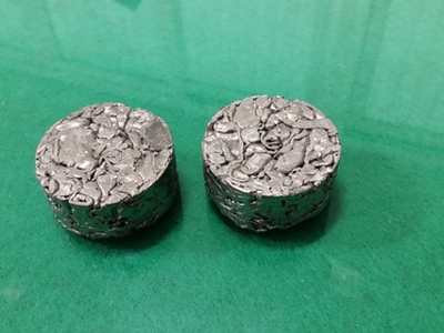 Two cylindrical metal-chip briquettes supplied as output-form examples